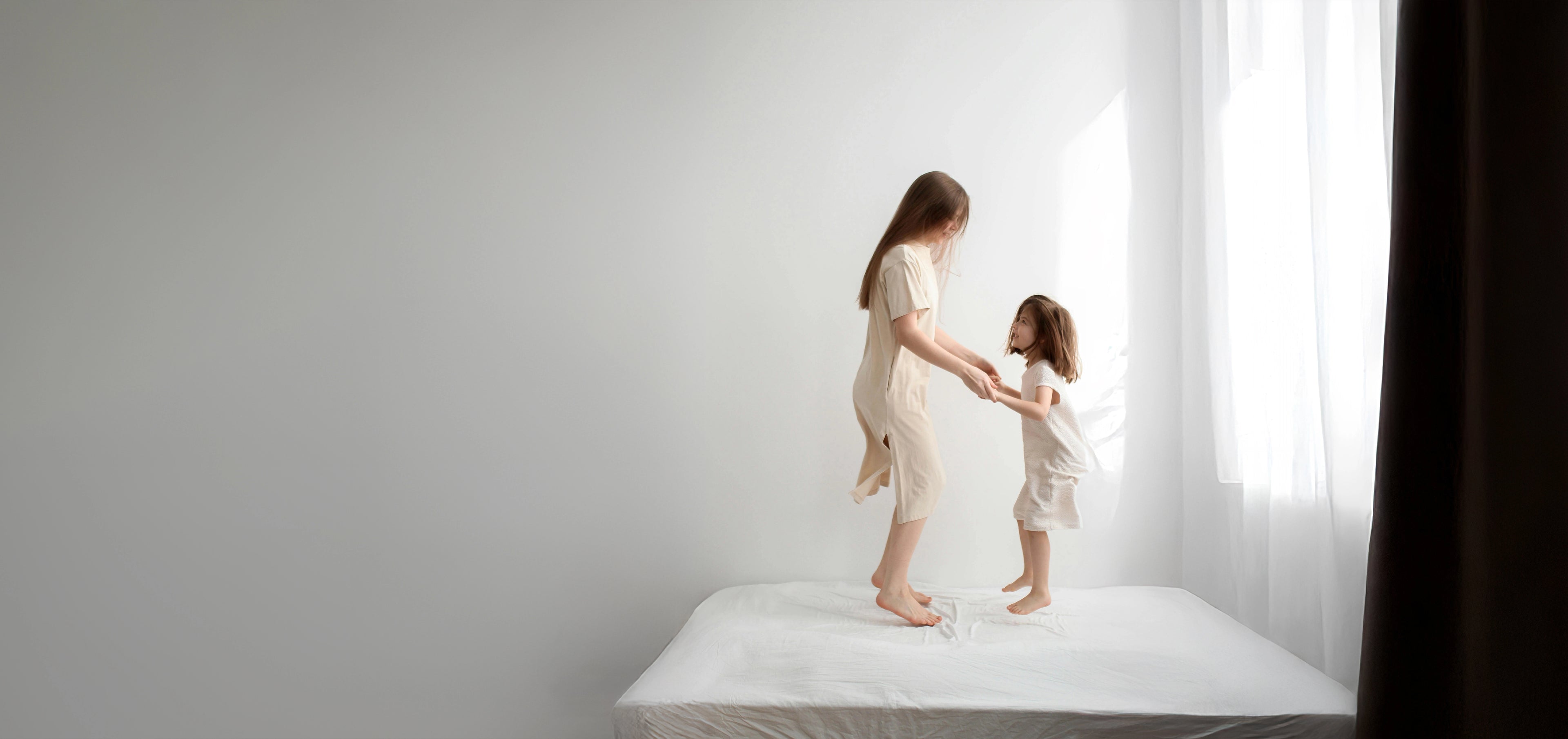 Mily Bedding Contact Interface, featuring a parent and child playing hand-in-hand on a bed, symbolizing connection, comfort, and family bonds.