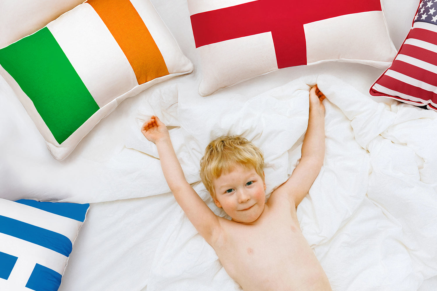 Mily Bedding's global market presence, showcasing a child lying on a bed surrounded by flags from various countries, symbolizing the worldwide reach and popularity of our products.